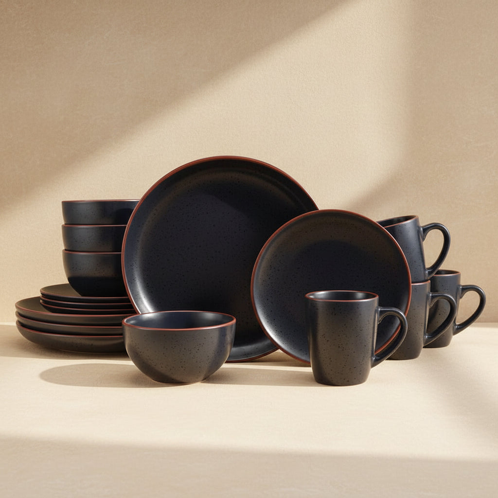 Black ceramic dinnerware set in a beige background