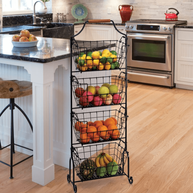 Laguna four tier adjustable standing storage rack with wire baskets in a kitchen filled with fruit