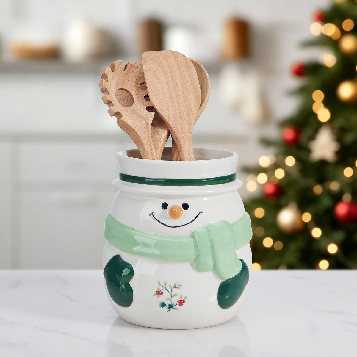 Snowman utensil gadget crock with wooden spoons inside and a smiling face