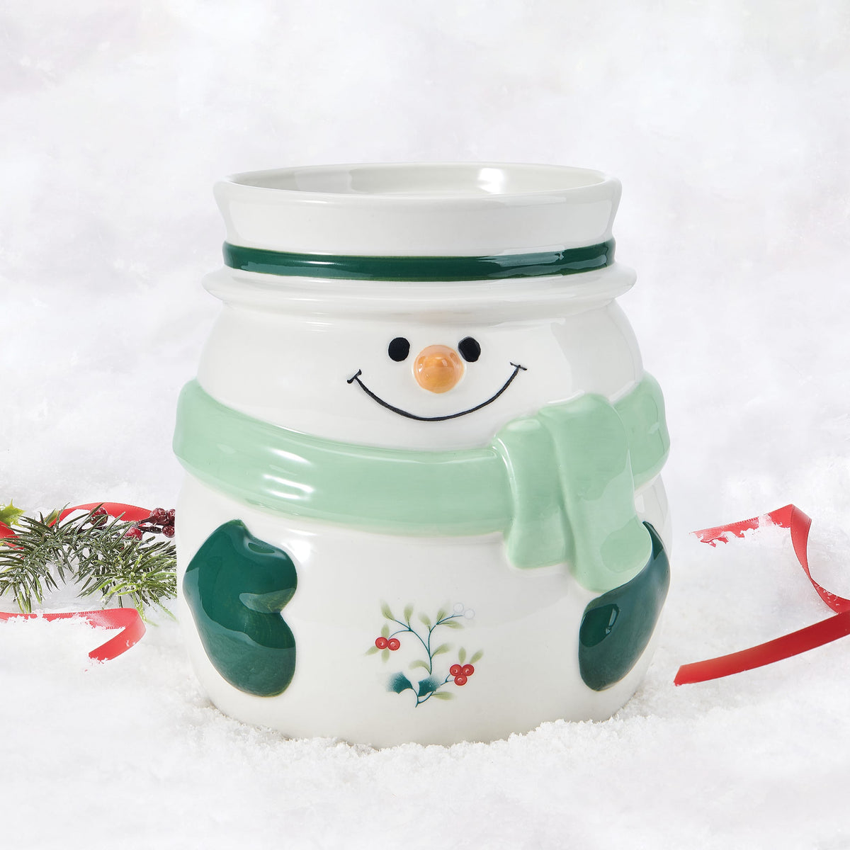 Snowman utensil crock with green scarf and holly pattern in a snowy scene