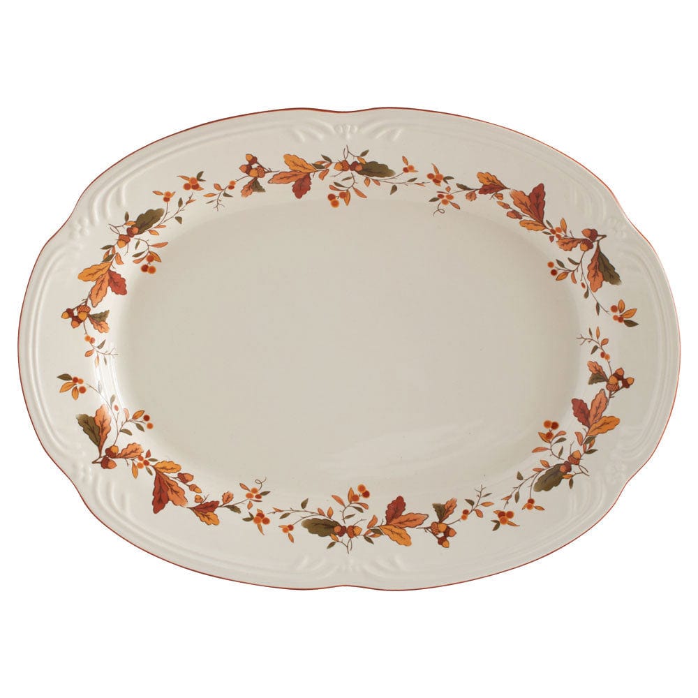Cream oval platter with a border of orange leaves and berries.