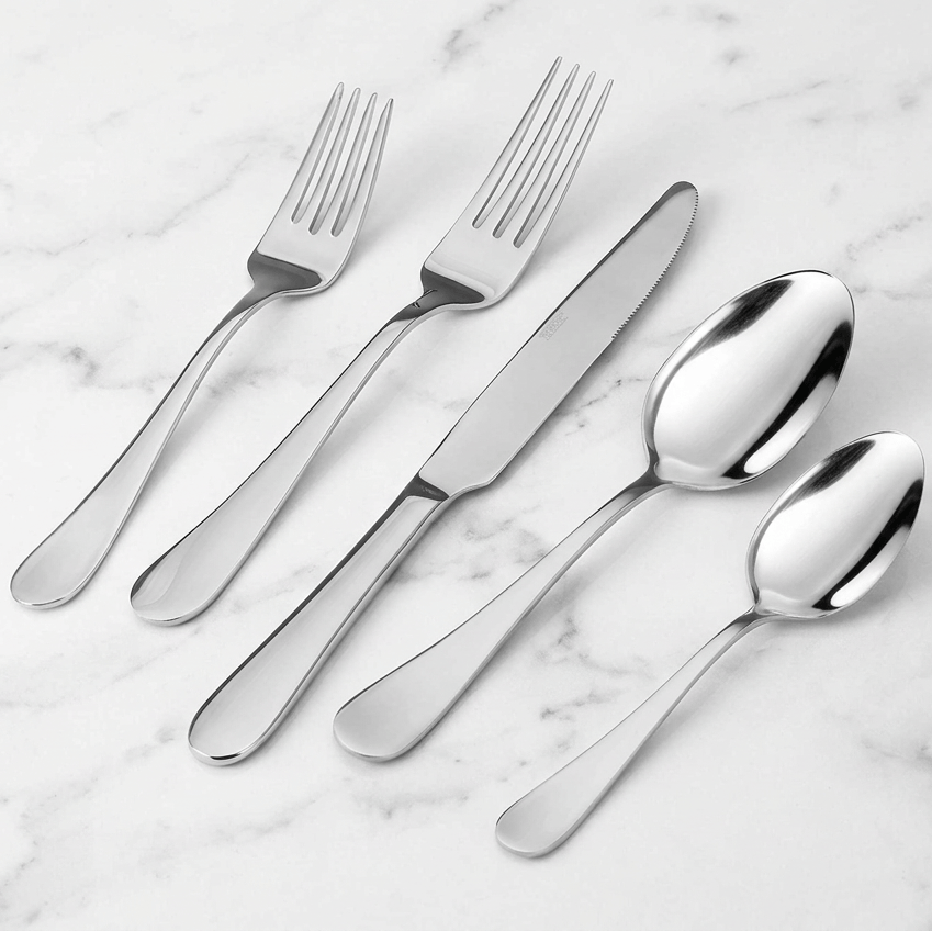 42 piece flatware set for eight displayed on a marble surface with forks knives and spoons