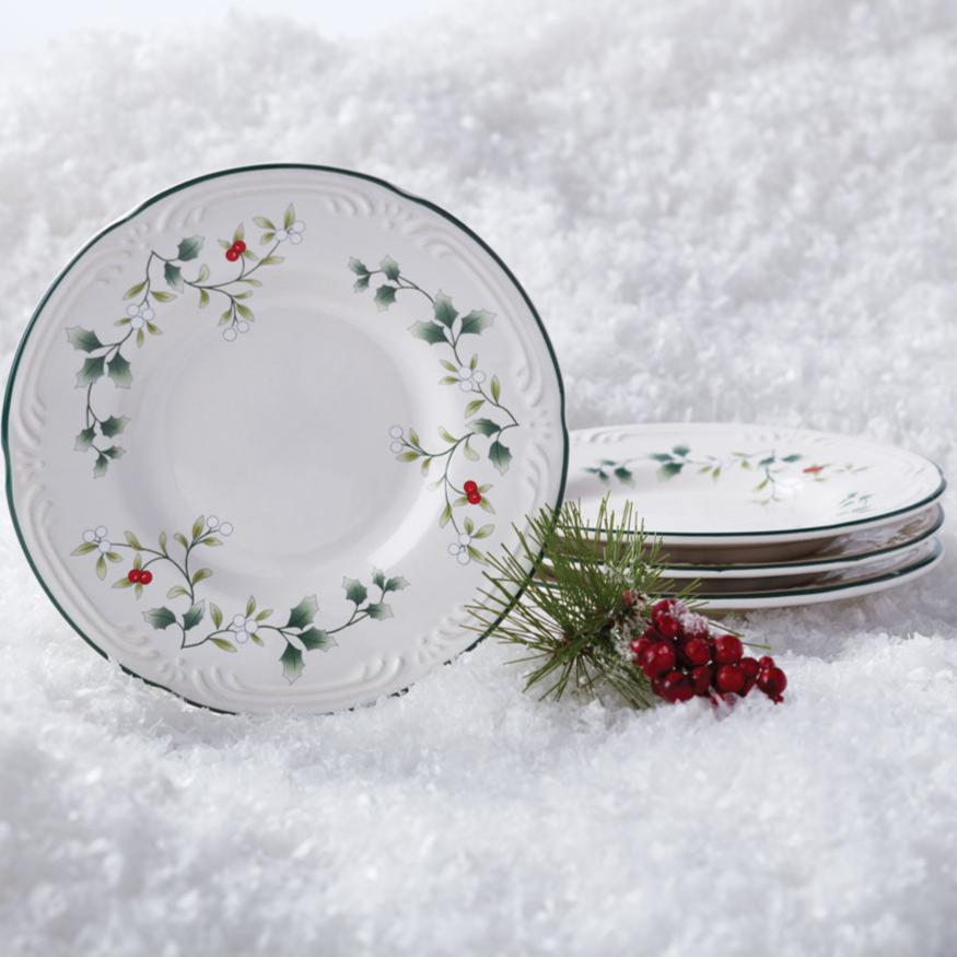 Winterberry bread and butter plate with holly motif and green edge set against a snowy background