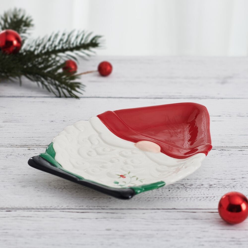 Winterberry gnome cookie plate laid flat on white wood surface with red interior and holly accent
