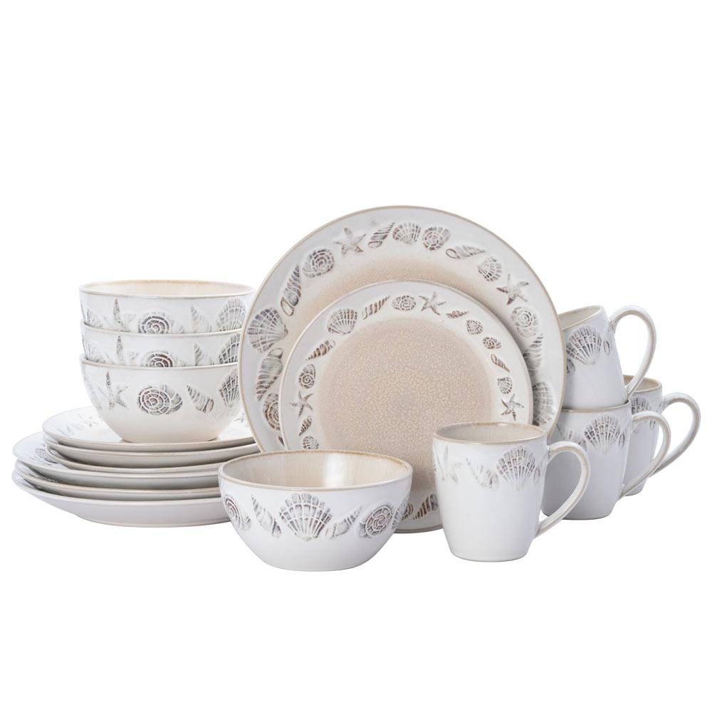 Panama 16 piece dinnerware set for four arranged on a wooden table with napkin and two dark goblets.