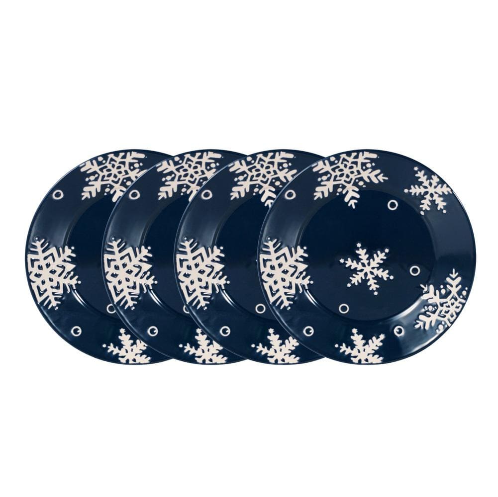 Set of four navy Snow Flurry salad plates with white snowflake patterns.