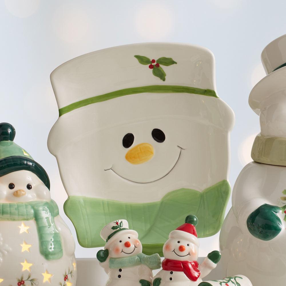 Winterberry snowman figural cookie plate close-up showing a smiling face with orange nose and green scarf