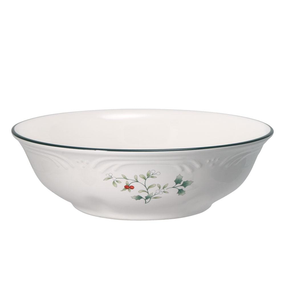 Winterberry vegetable serve bowl with yellow exterior, sunflower motif and red dotted rim on a wooden surface.