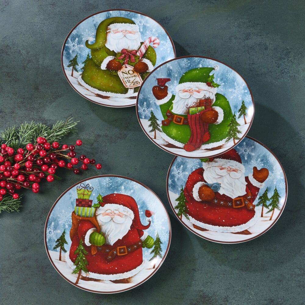 Four Santa salad plates on a dark teal backdrop, each showing Santa with gifts and trees in a snowy scene.