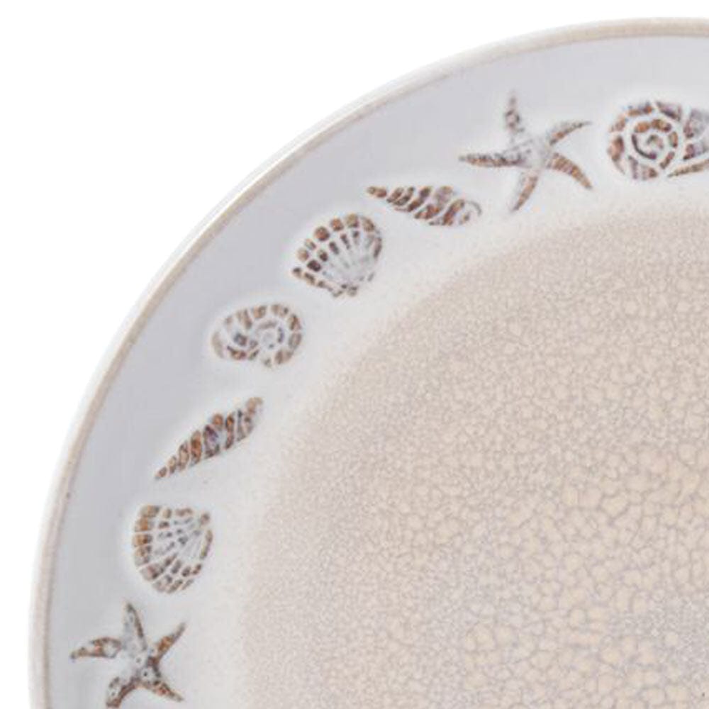 Close-up of a Panama dinner plate edge with a seashell border and speckled beige glaze