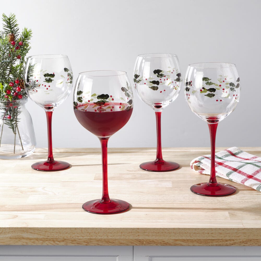 Winterberry set of four hand painted wine goblets with holly pattern and red stems.