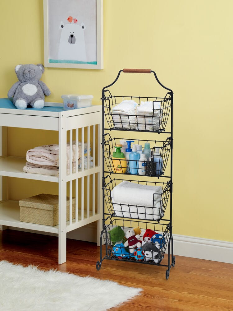 Laguna 4 tier adjustable standing storage rack with black wire baskets stands beside a white changing table against a yellow wall, holding towels and plush toys.