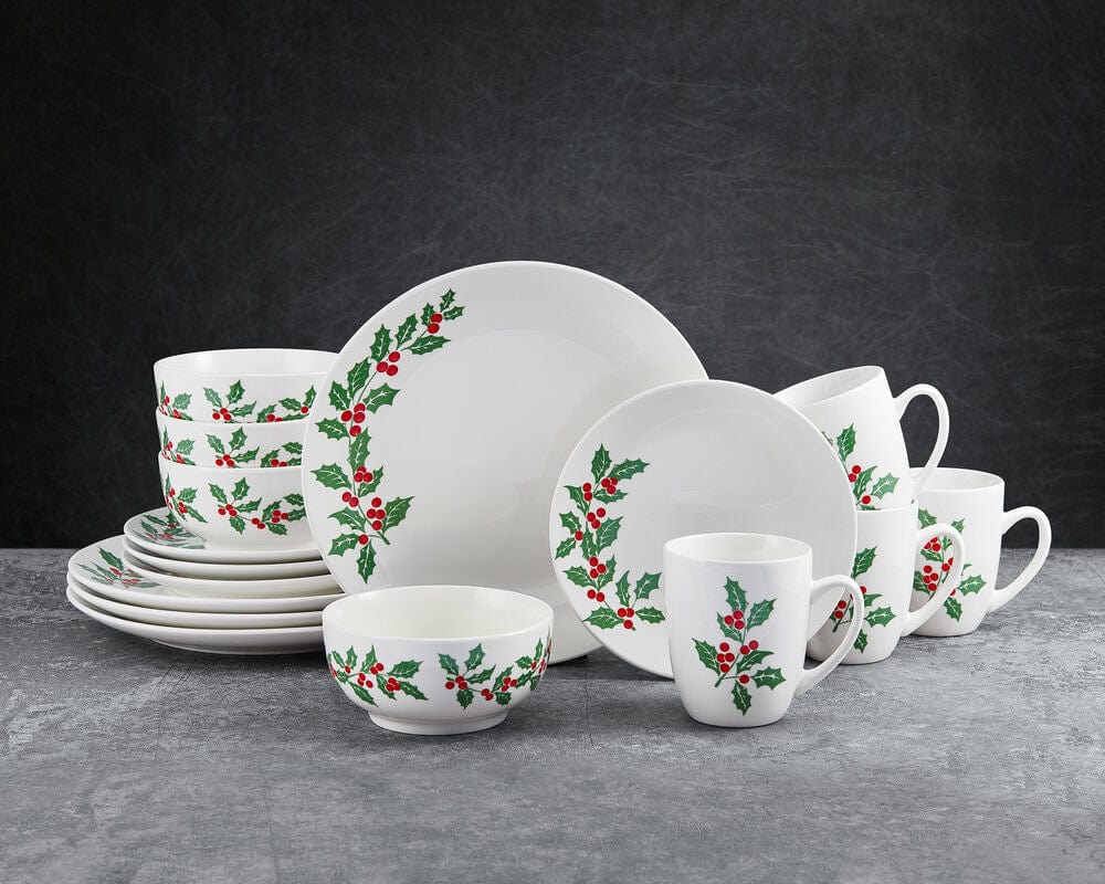Holly Cheer white dinnerware set for four featuring holly berry motif on plates bowls and mugs