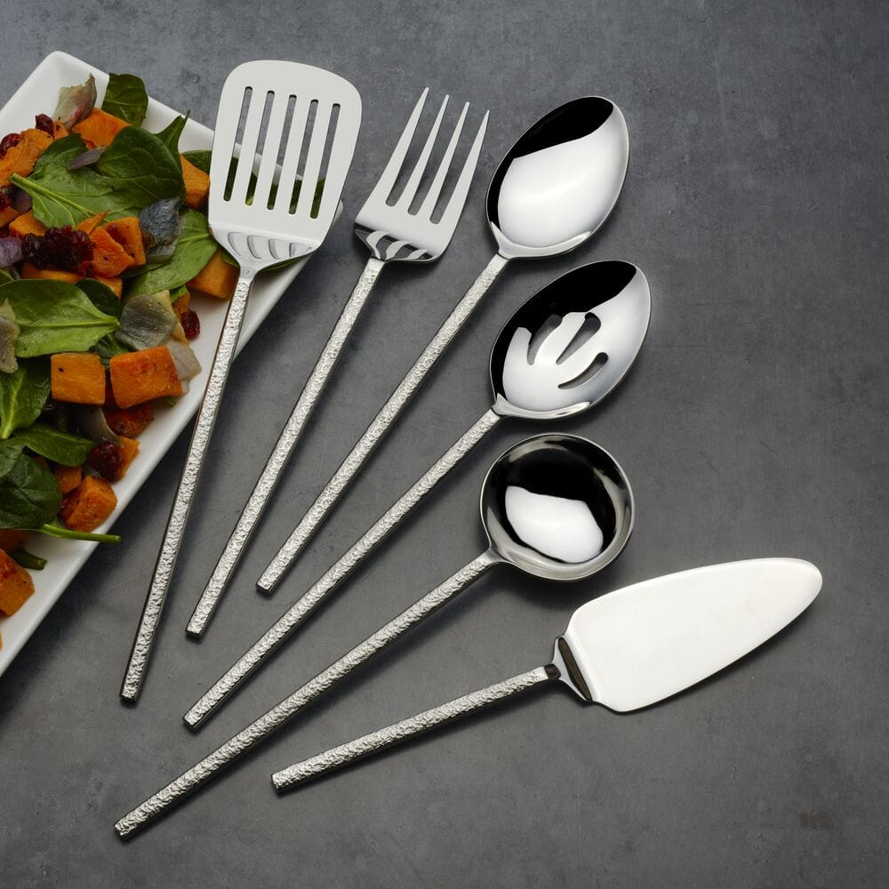 Paragon Forged 6 piece serving set arranged on a dark surface next to a salad plate