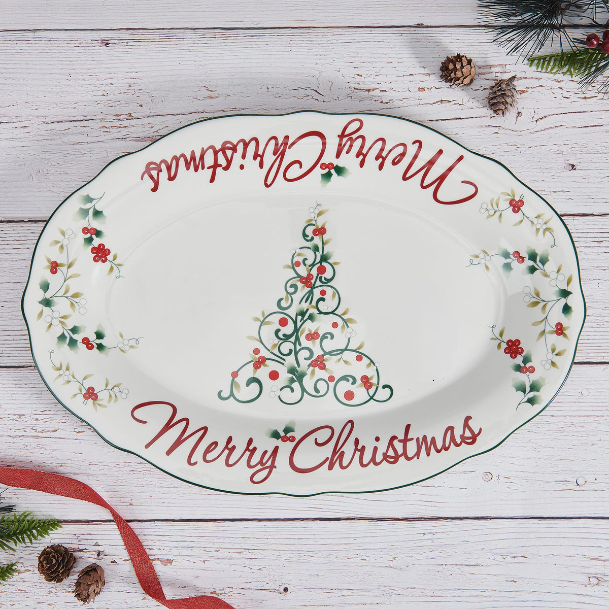 Winterberry Merry Christmas platter with red script and holly accents on a white plate.