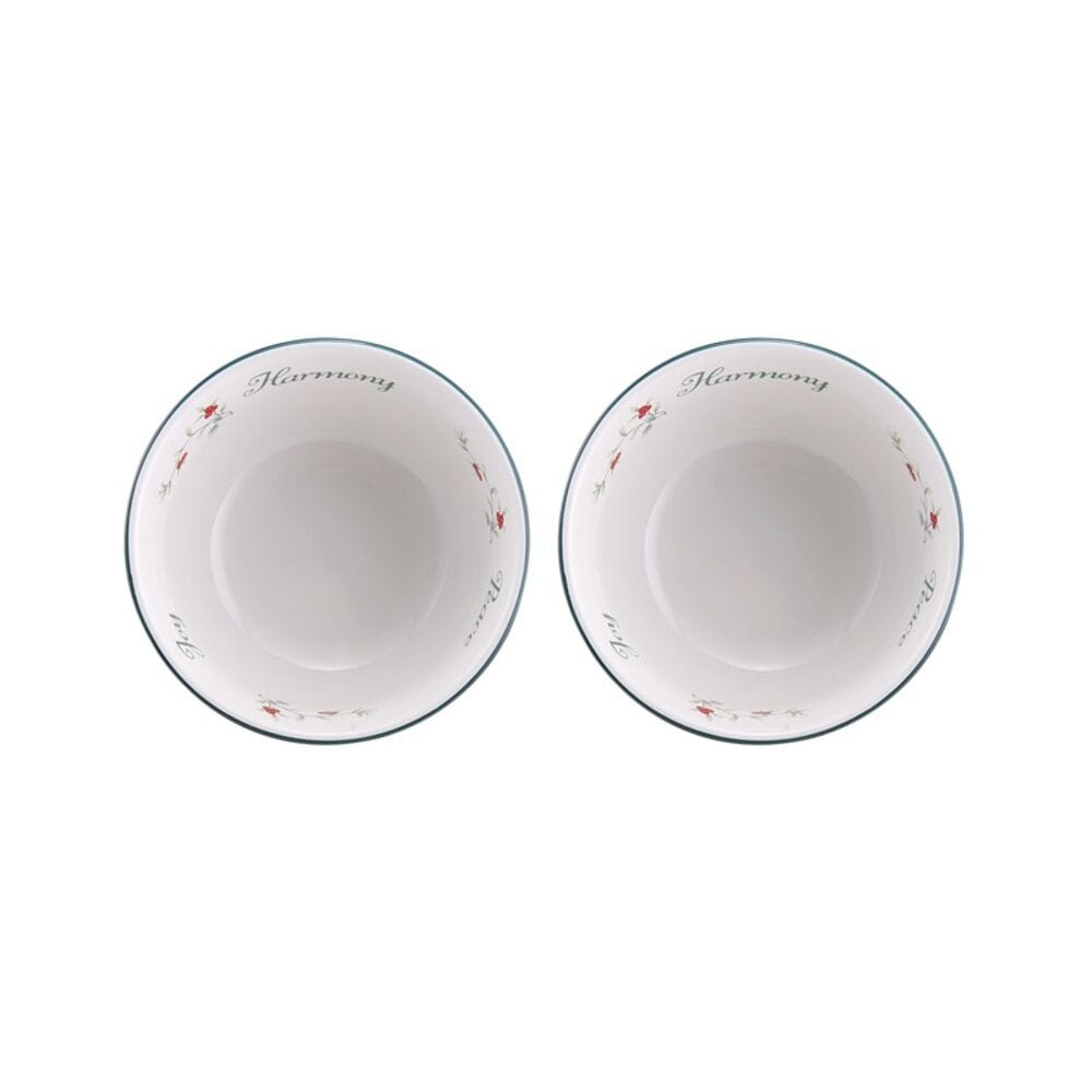 Two Winterberry Harmony dessert bowls viewed from above, featuring Harmony on the rim and holly motif.