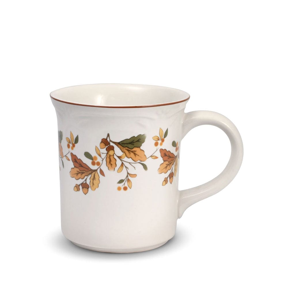 White ceramic mug with autumn berry vine pattern and brown rim.