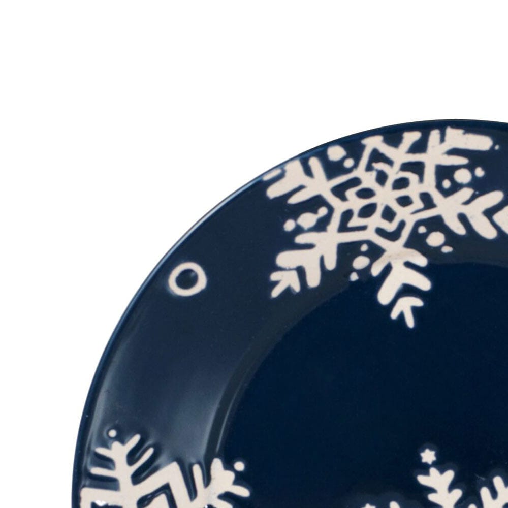 Close up of navy Snow Flurry plate showcasing a white snowflake pattern.