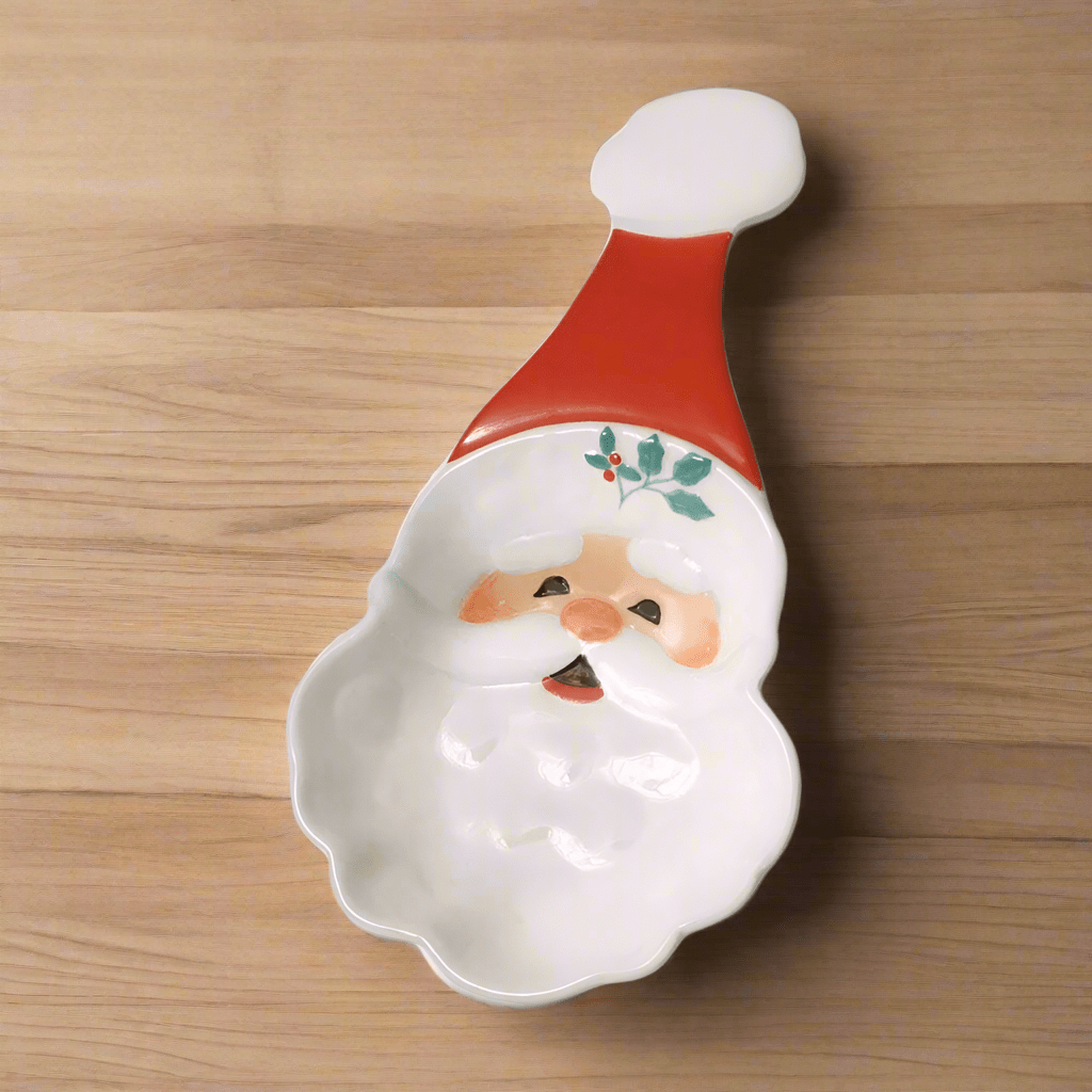 Winterberry Jolly Santa Spoon Rest shaped as Santa with red hat and white beard on a wooden surface