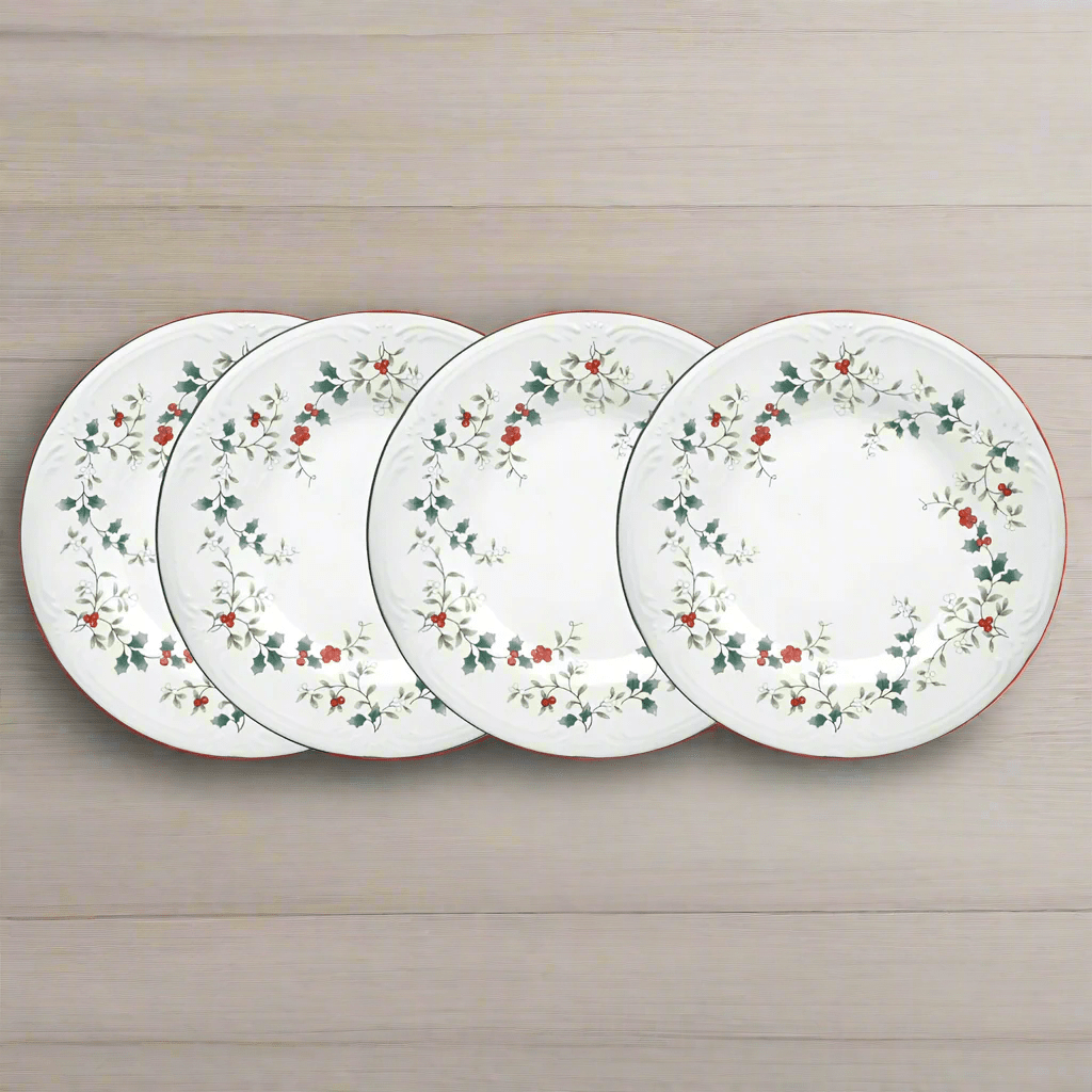 Winterberry Set of 4 luncheon plates with holly border displayed on a light wood surface