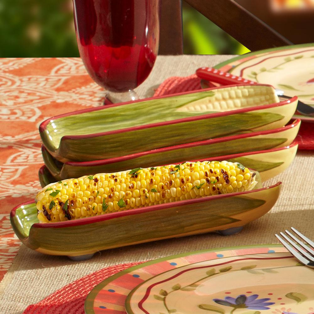 Napoli corn shaped ceramic dish with grilled corn on the cob inside, stacked on a table.
