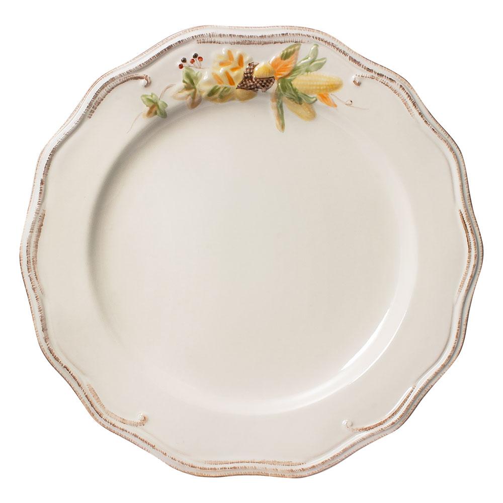 Four Plymouth dinner plates with cream glaze and a delicate floral border along scalloped rims.
