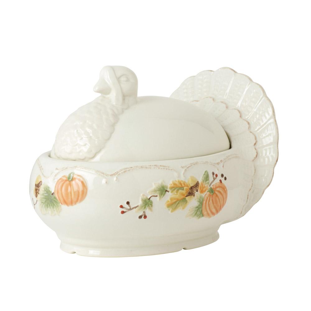 Plymouth turkey shaped covered serving dish shown from the side with a tail fan back and autumn pumpkin motif