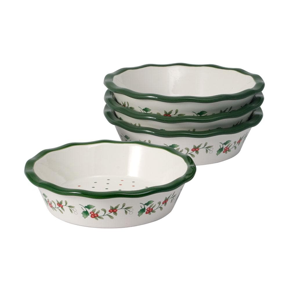 Winterberry mini pie plates stacked with green scalloped rims and holly garland on white ceramic