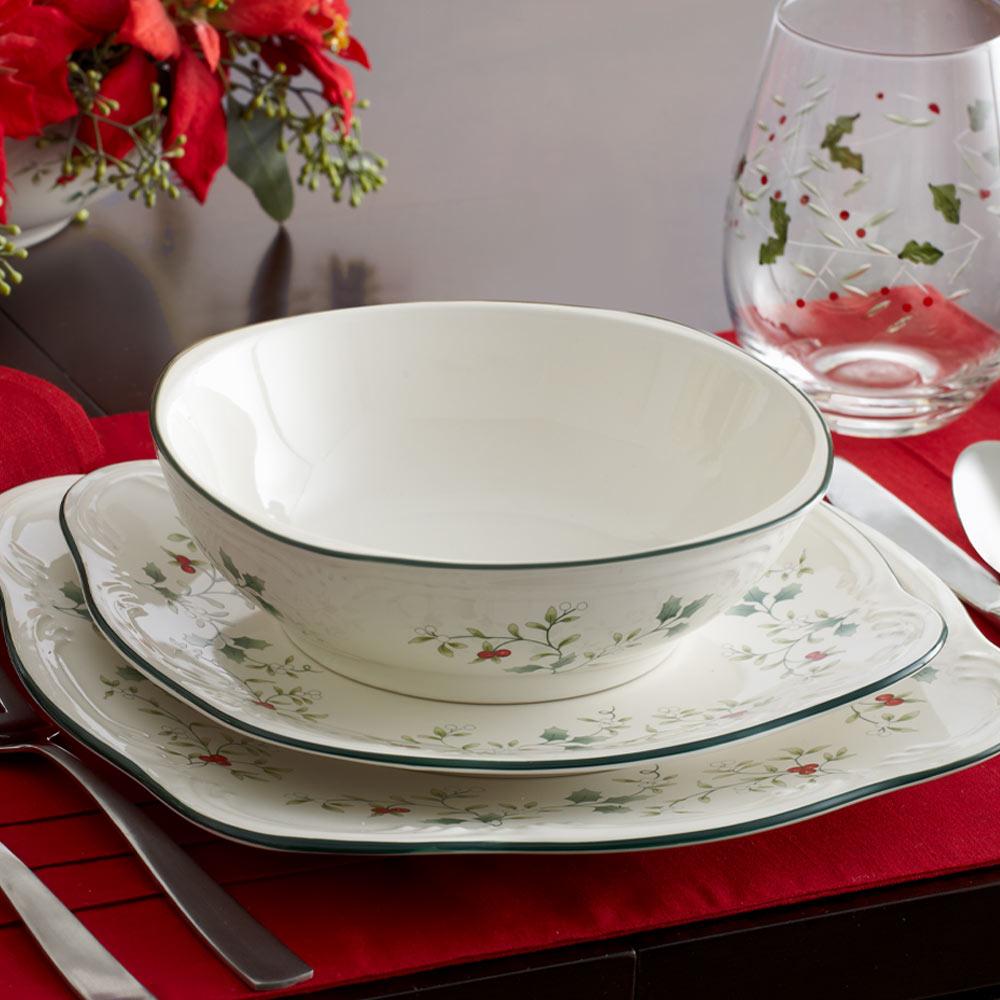 Winterberry four piece square bowls with matching plates featuring holly and greenery on white glaze