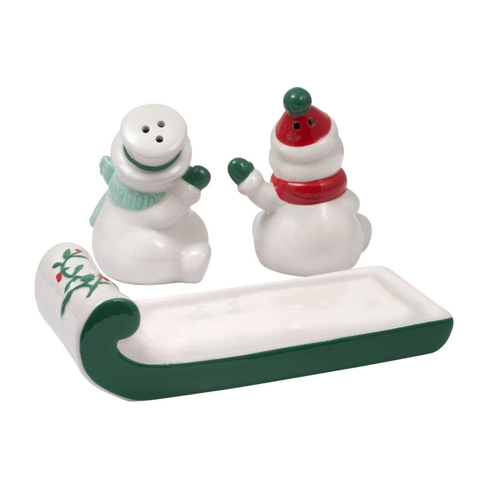 Back view of Winterberry snowmen on sled salt and pepper set showing two snowmen with hats and scarves beside a curved green base