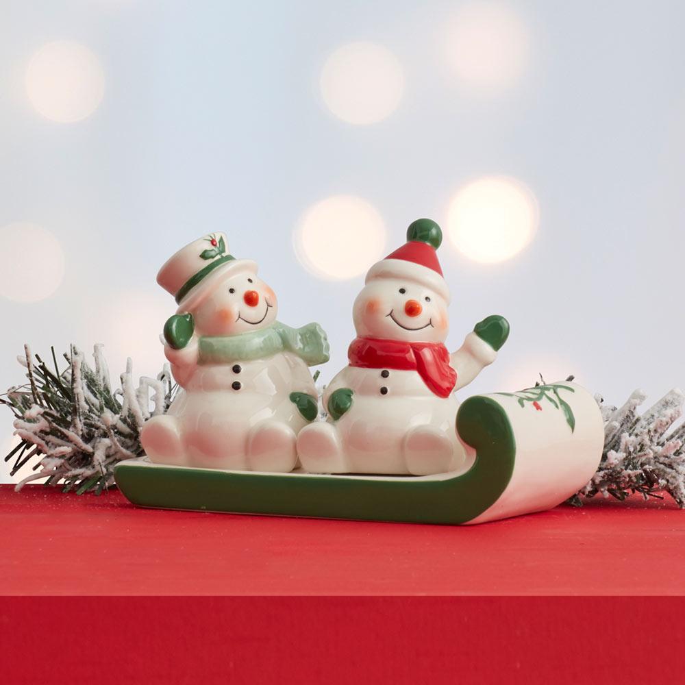 Winterberry snowmen on sled salt and pepper set featuring two smiling snowmen on a green sled